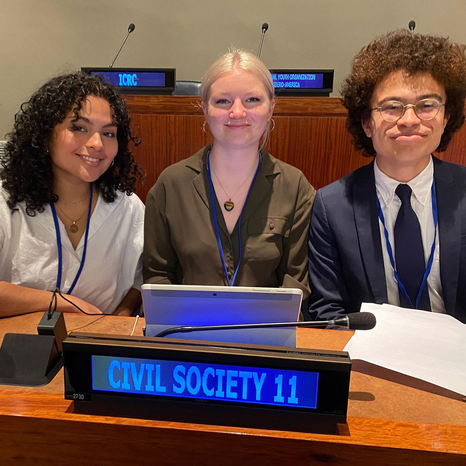 Pace University students Jasmine Cintron ‘25, Antje Hipkins ‘24, and Ellis Clay ’25 sitting together the United Nations General Assembly First Committee