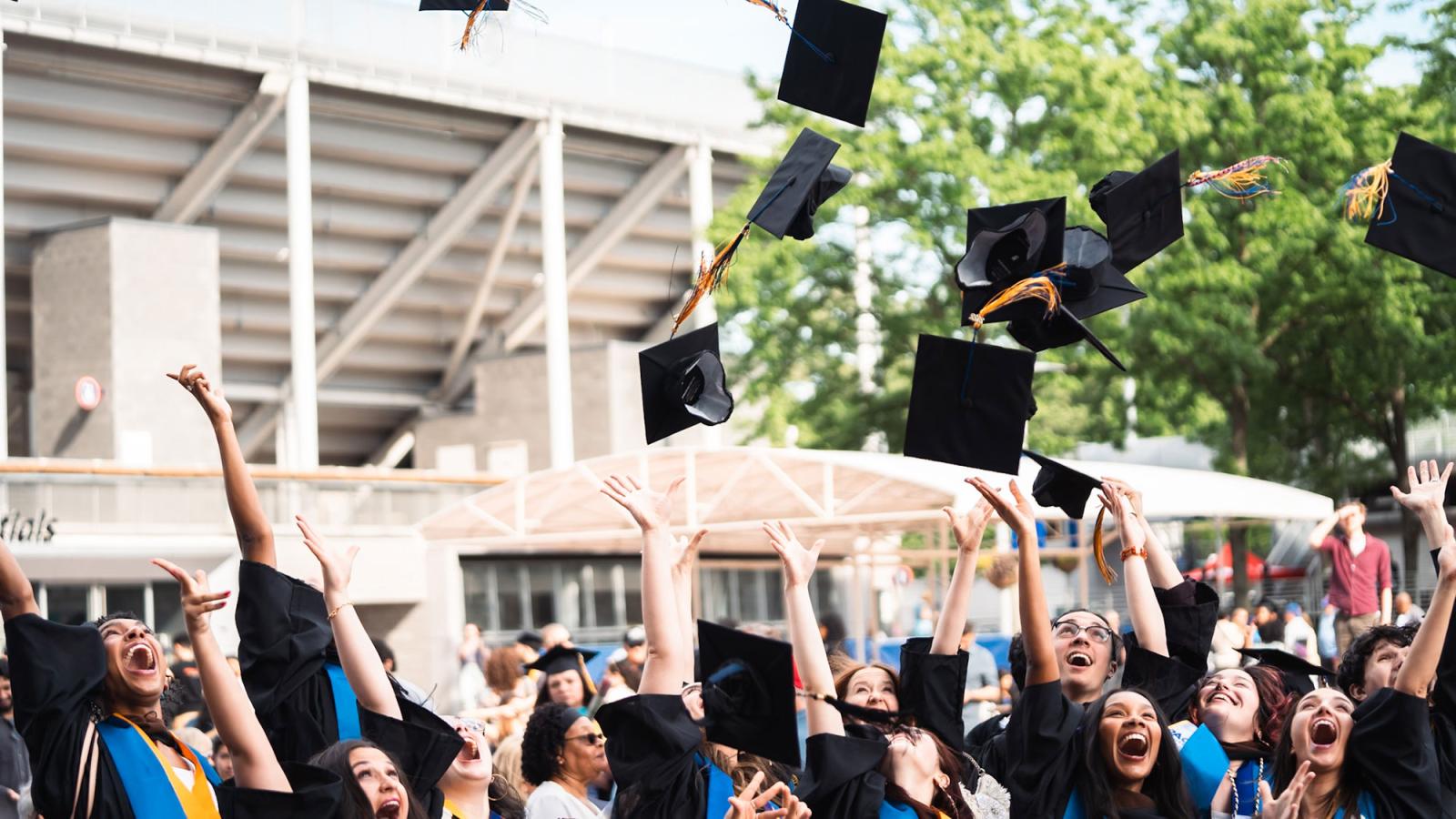 Group of Pace University students celebrating their graduation.