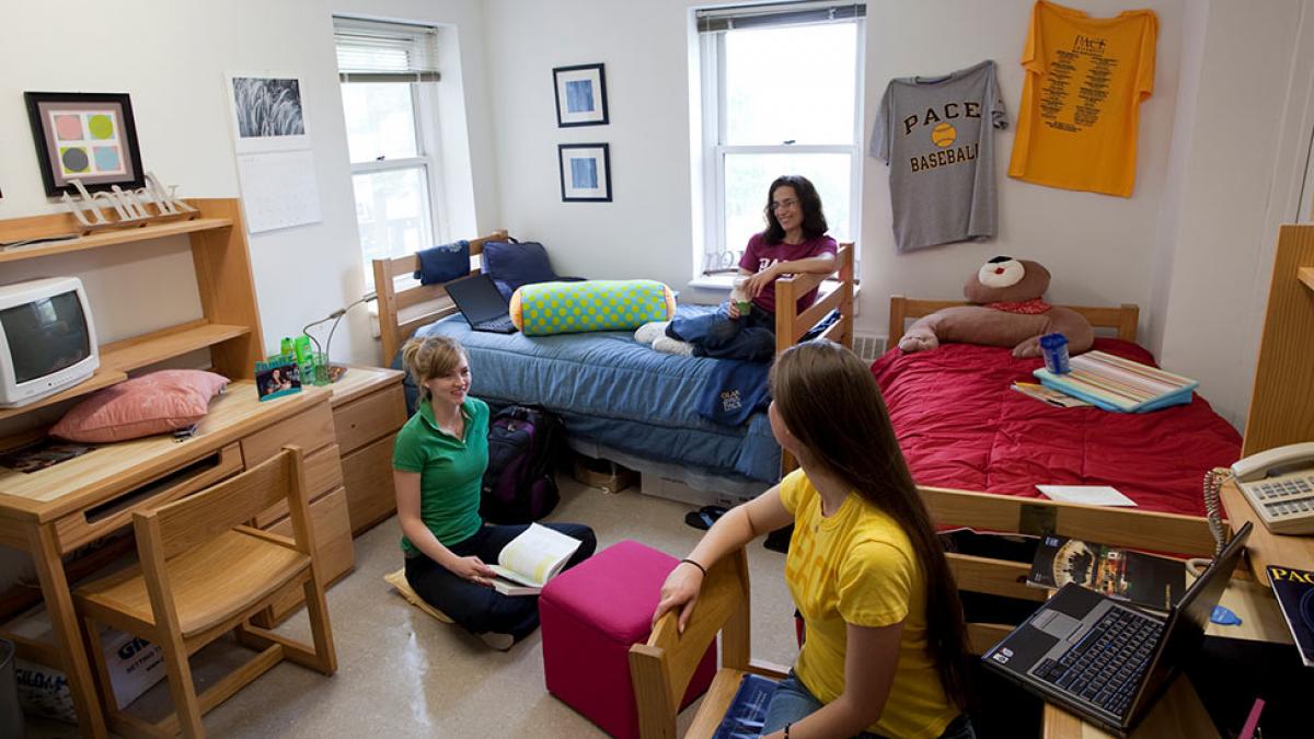 Students talking in a room in one of the residence halls.