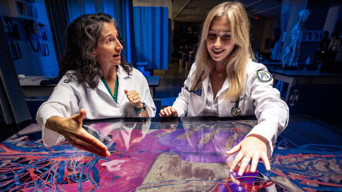 Professor working with a student on the SECTRA table.