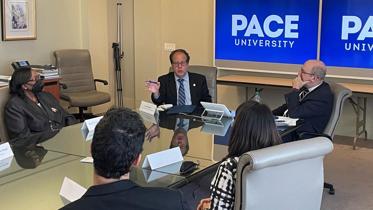 Assemblymember Tom Abinanti and Pace University President Marvin Krislov speaking to a group of people