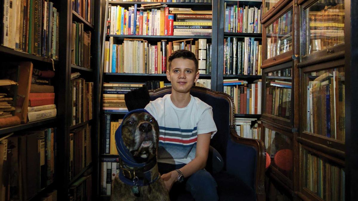 Shahab Gharib in family library with his dog, Bumble