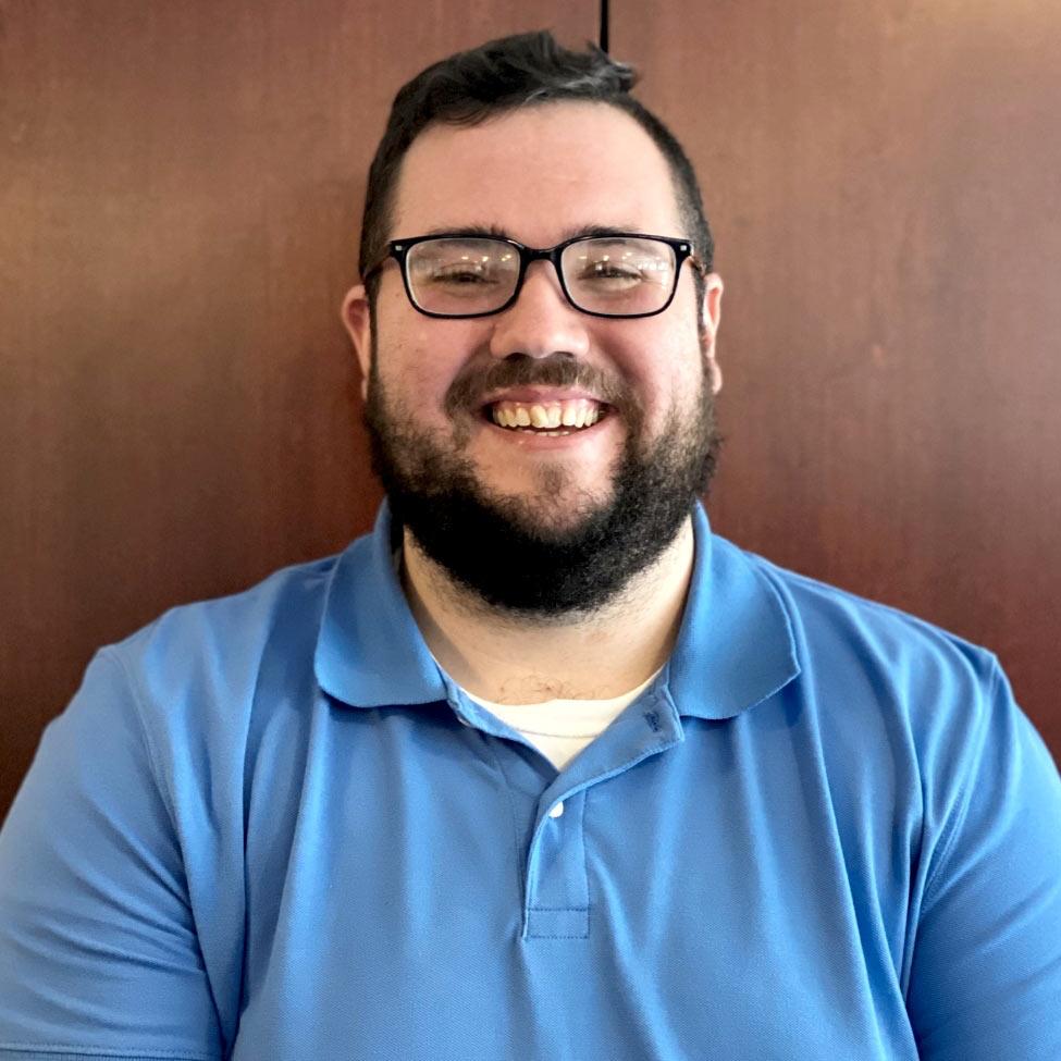 smiling man with glasses and blue shirt