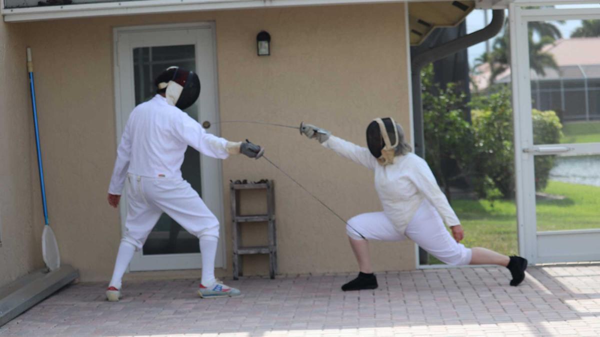 visiting professor Debra Moss Vollweiler fencing against opponent