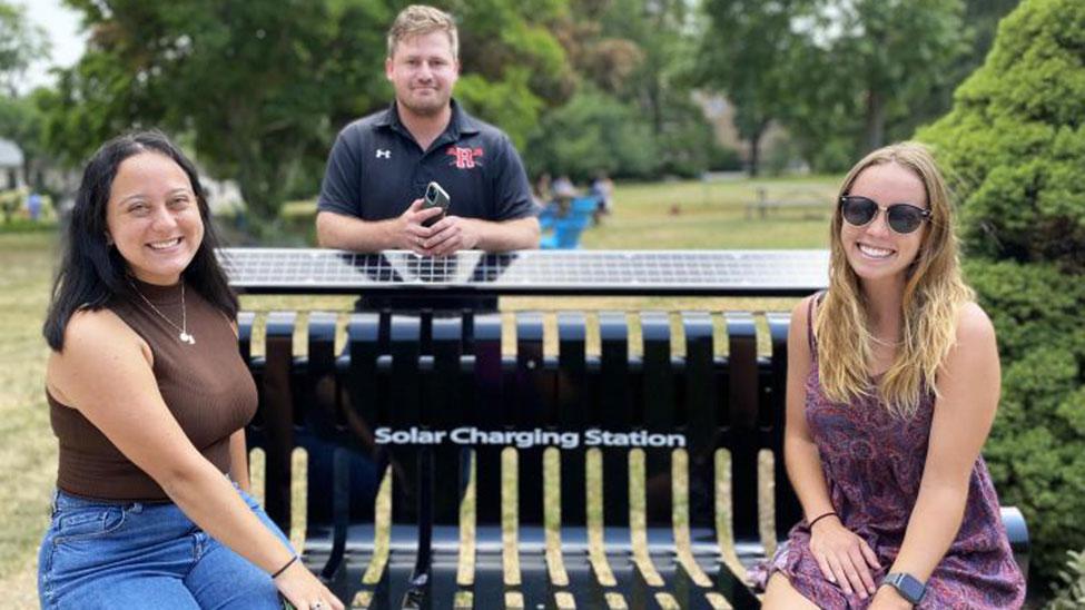 image of new solar charging bench with students in quad of Elisabeth Haub School of Law in White Plains