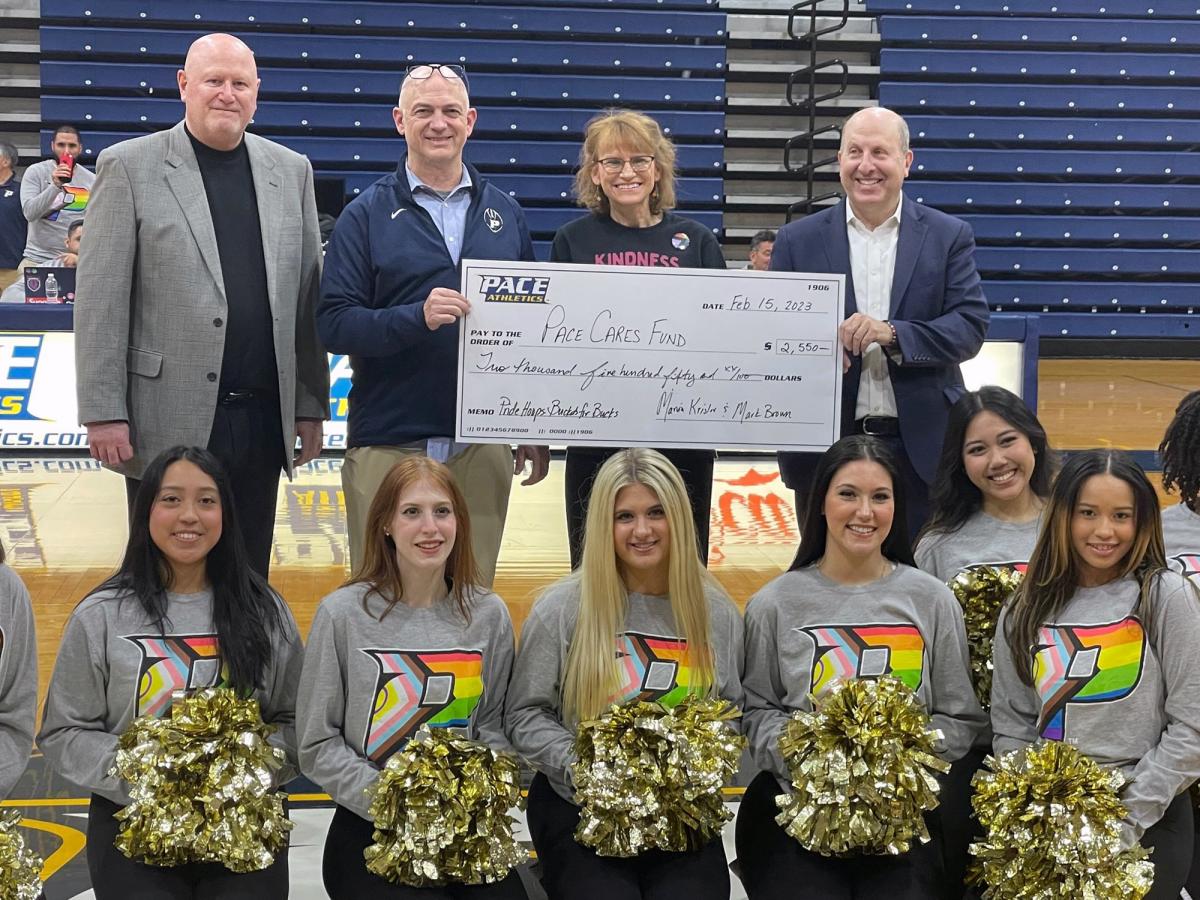 people holding a giant check