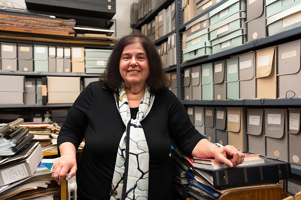 Ellen Sowchek stands in front of rows of organized files