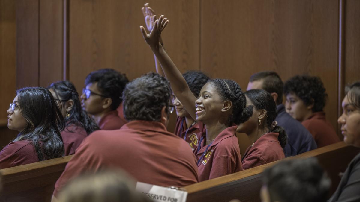 Student raising hand in court during Elisabeth Haub School of Law at Pace University second circuit program