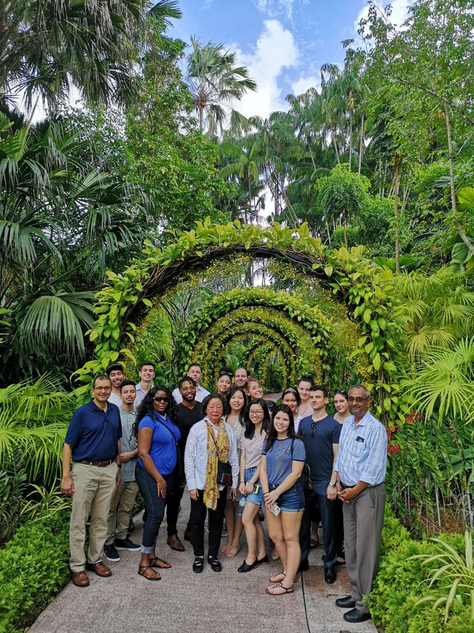 group of Lubin students standing with Prof. Gopalakrishna in a tropical garden in Singapore 