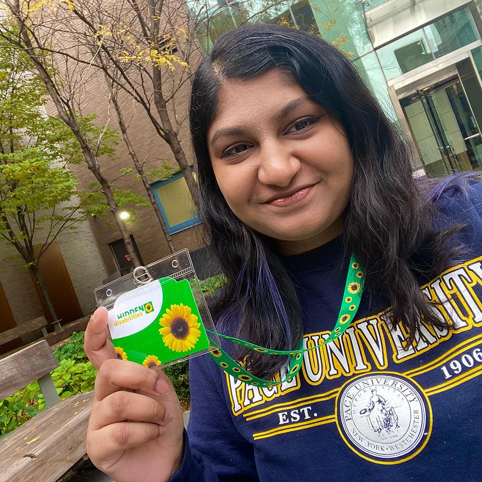 Samara Durgadin posing with her sunflower lanyard. 