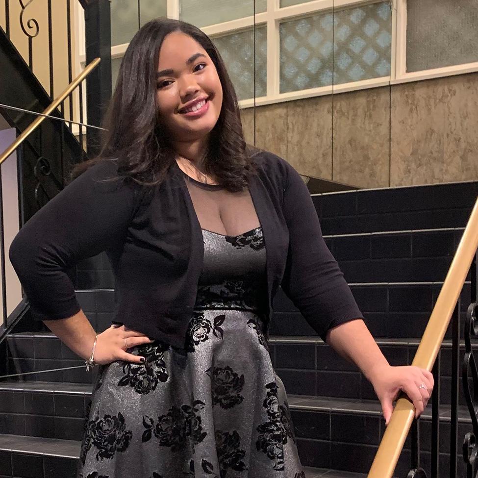 Pace student Valentina Rojas Abreu stands in front of a staircase  