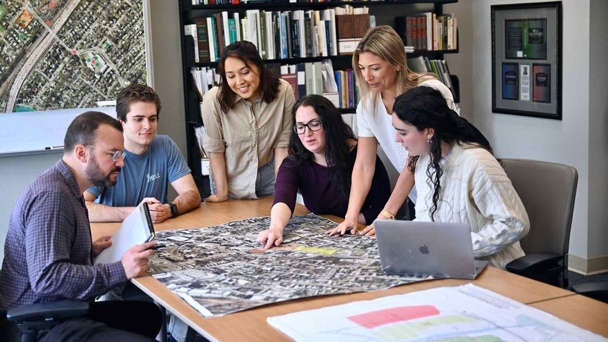 Land Use Directors Tiffany Zezula and Jessica Bacher with students reviewing map