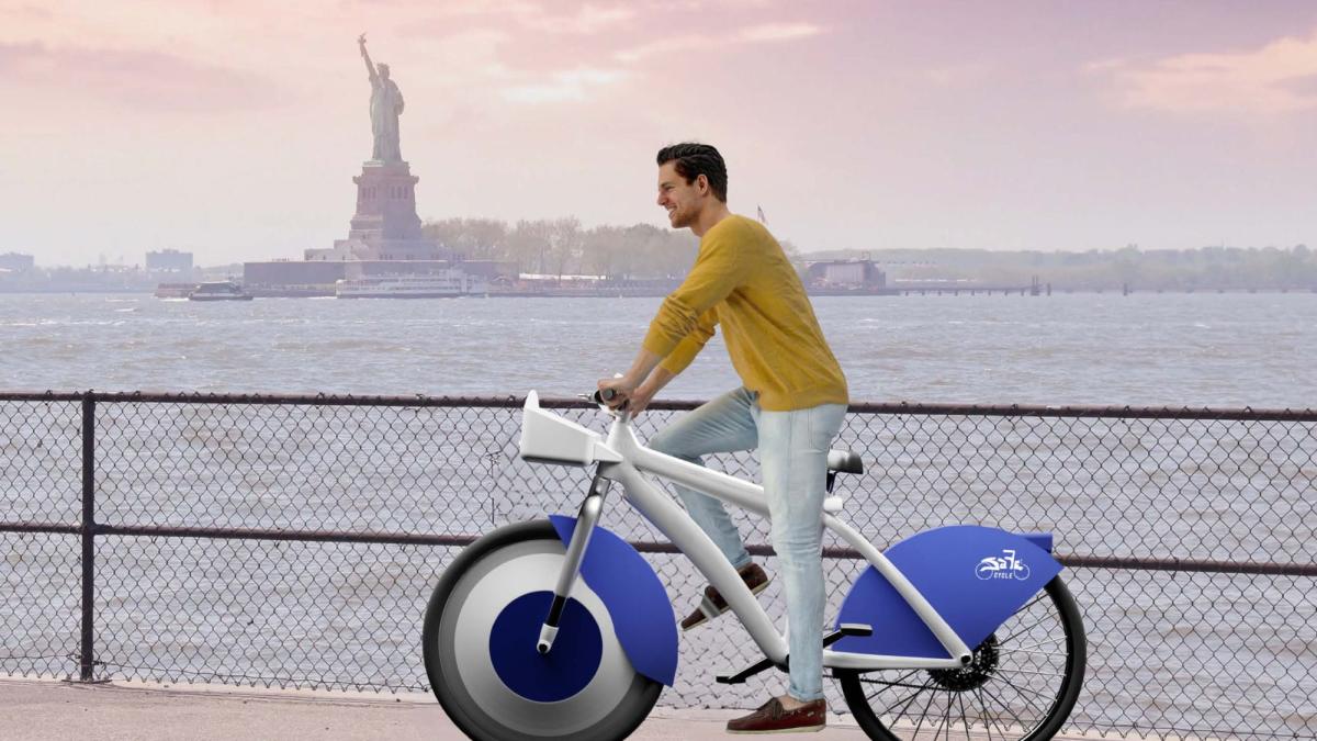 A visual representation of Team Bubble-Tea's project SafeCycle. A man riding an e-bike on an NYC promenade, with the Statue of Liberty in the background.