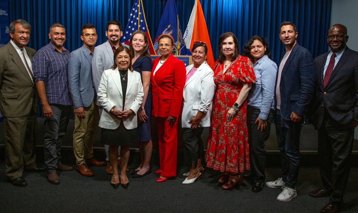 Pace University Public Administration professor Rebecca Tekula, PhD, standing with the Westchester County Hispanic Advisory Board