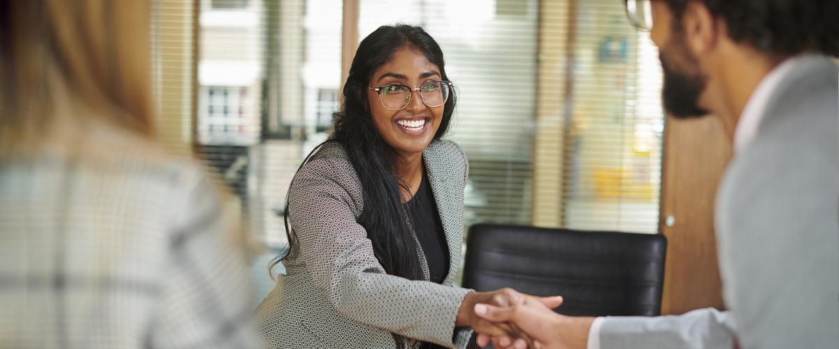 Elisabeth Haub School of Law student shaking hands with another person