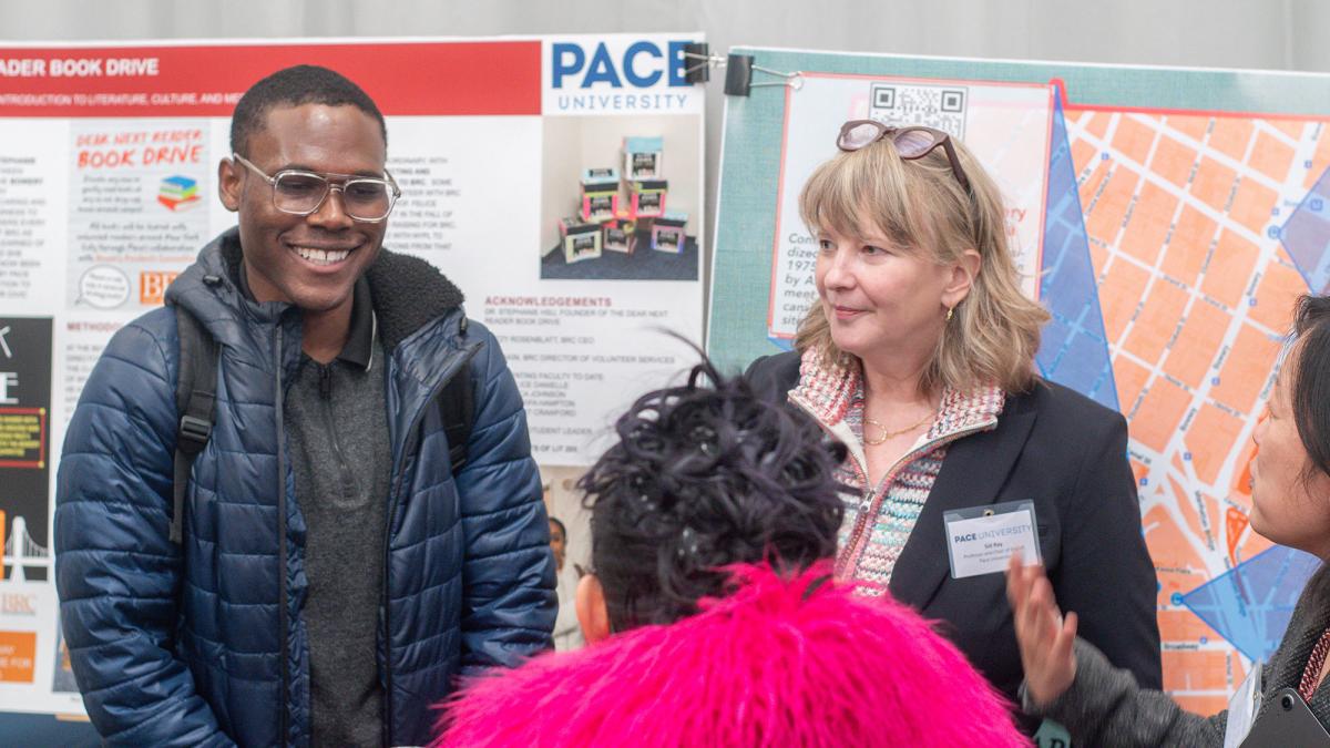 Student and Professor conversing at a poster presentation