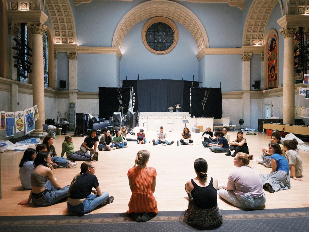 Pace University's Peace and Justice Studies and English students sitting in a circle and working with the Bread and Puppet Theater to express social justice through art.