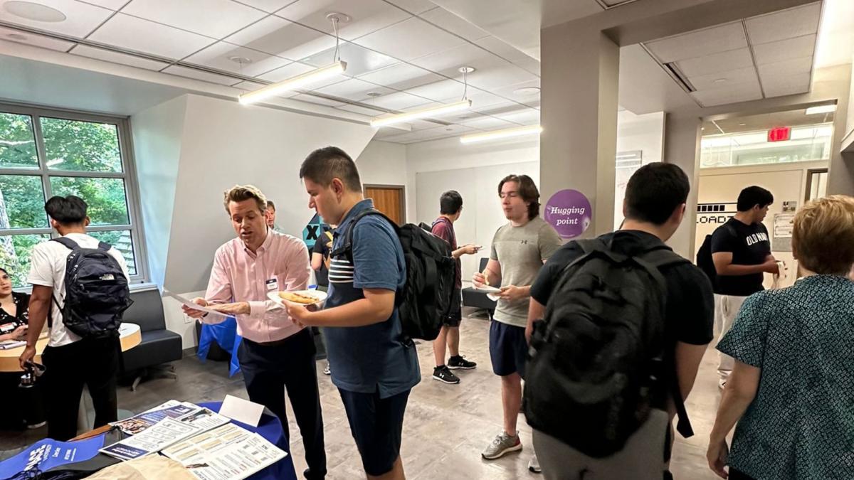 Seidenberg students and faculty mingling and talking in the Seidenberg Lounge at the Pace University Pleasantville Community Day.