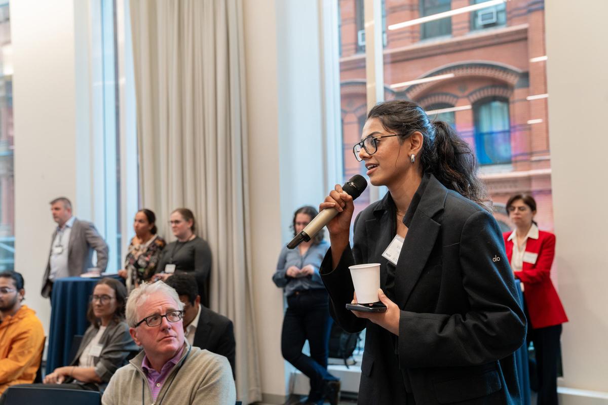 Attendee at the inaugural Pace University Fintech Conference asking the panel of speakers a question.