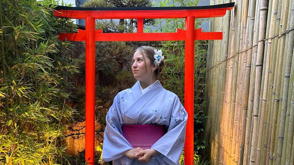 Kristina Nasteva wearing traditional Japanese clothing and posing for the camera. 