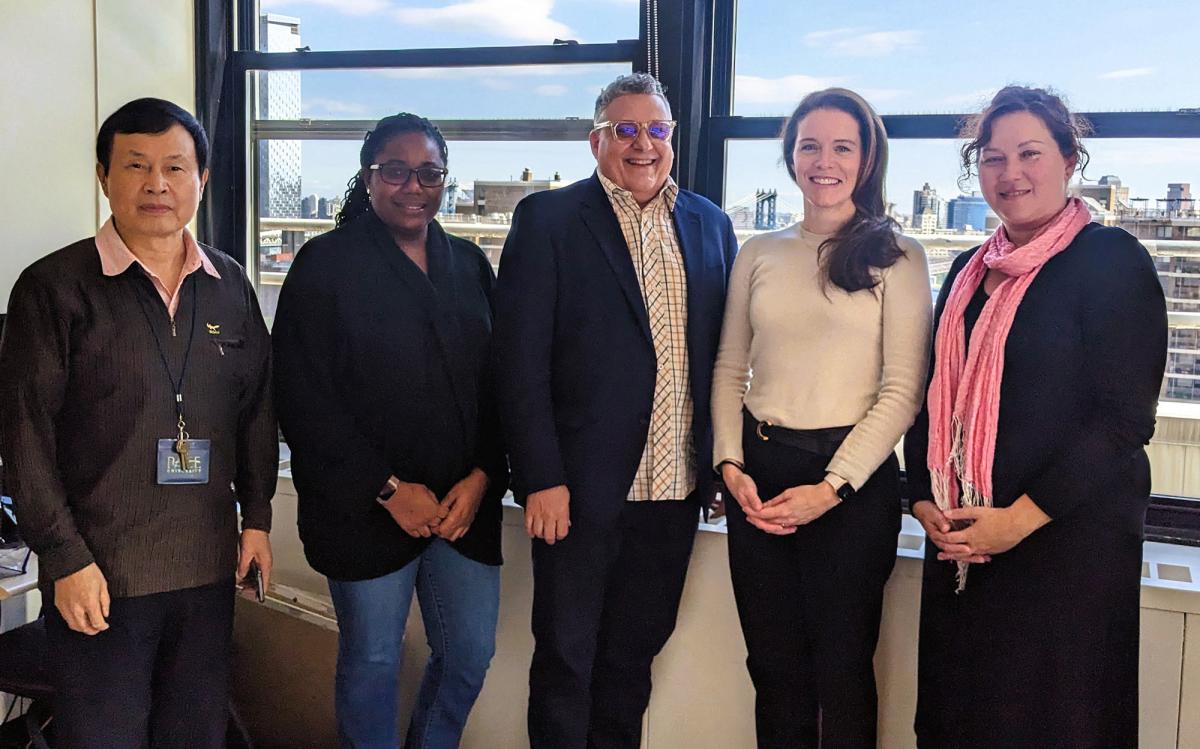 Pace University Public Administration faculty members standing in front of a window