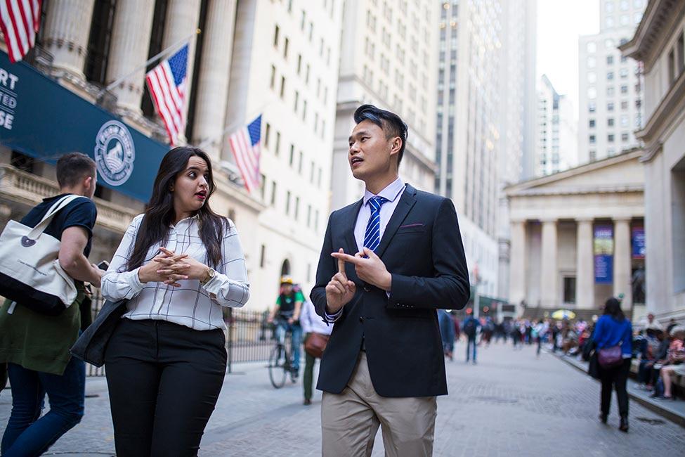 Two Pace graduate students walking on Wall Street