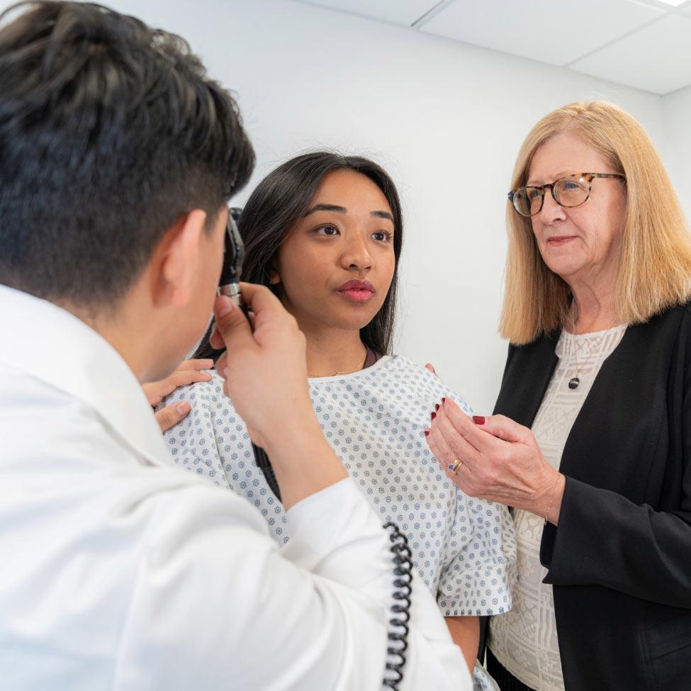 College of Health Professions Lenox Hill Physician Assistant program students examining a patient with Professor support.