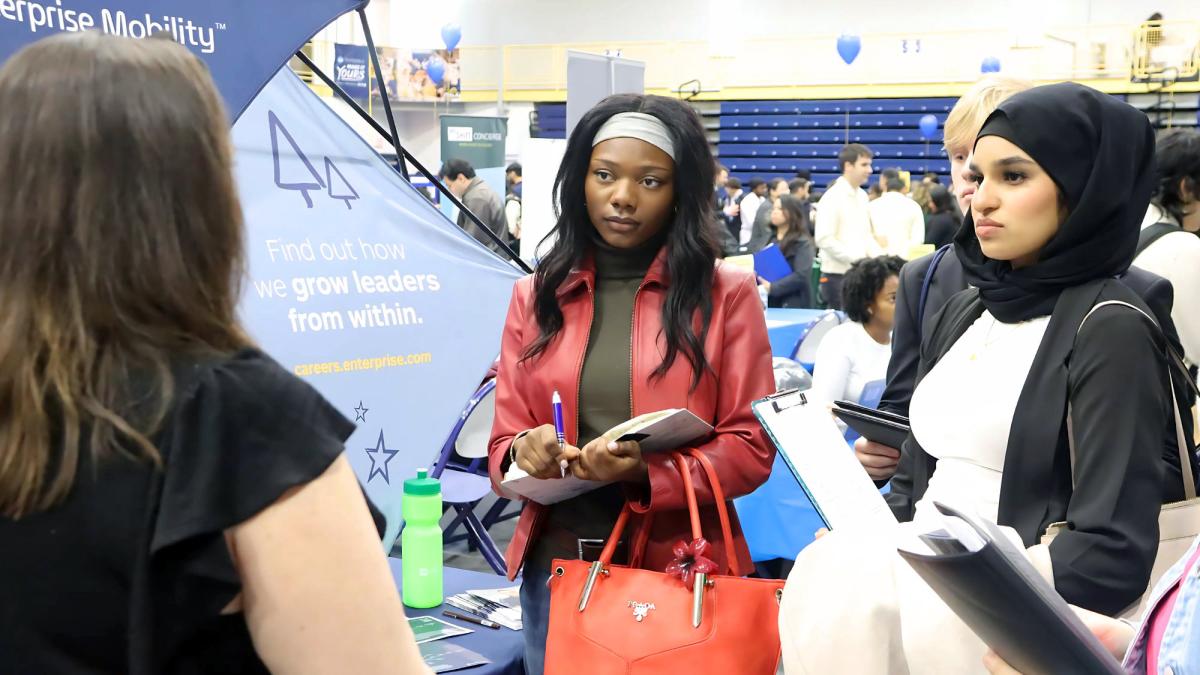 Pace University students talking to a job recruiter at the 2025 Spring Career Fair.