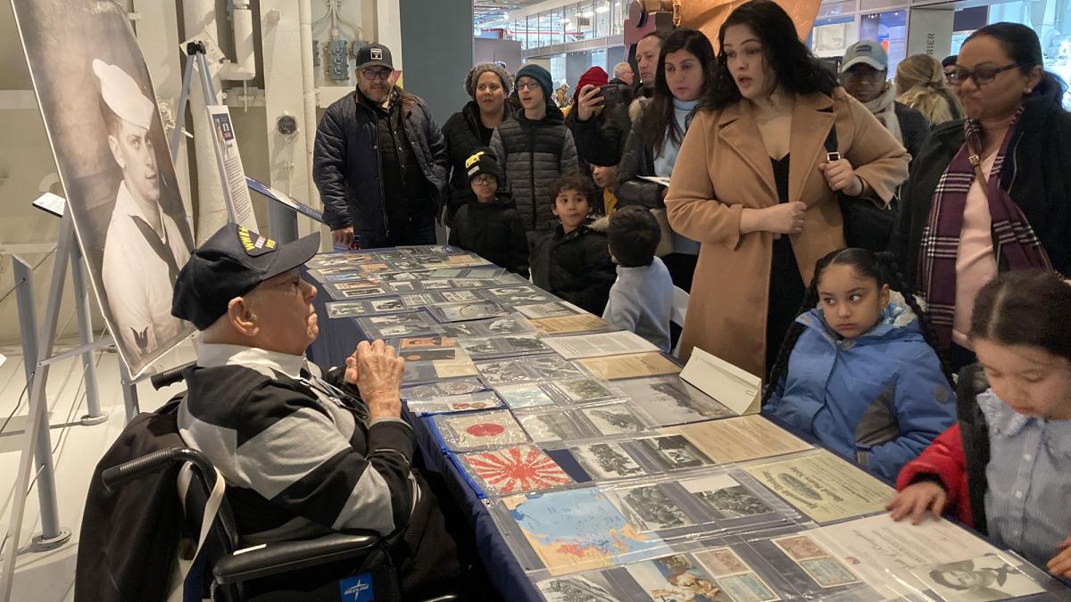 Pace University alumni Arthur Grabiner ’50 speaking to visitors as a volunteer at the Intrepid Museum, 2024.