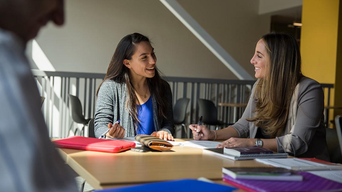 A student and a counselor talking and laughing.