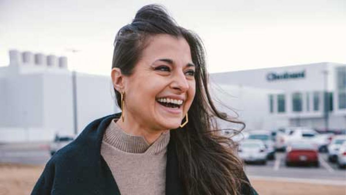 woman with dark hair laughing