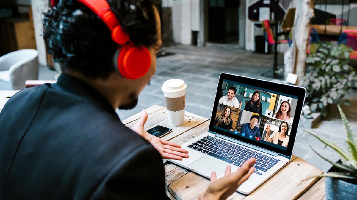 a man speaks with six people through a video conferencing application