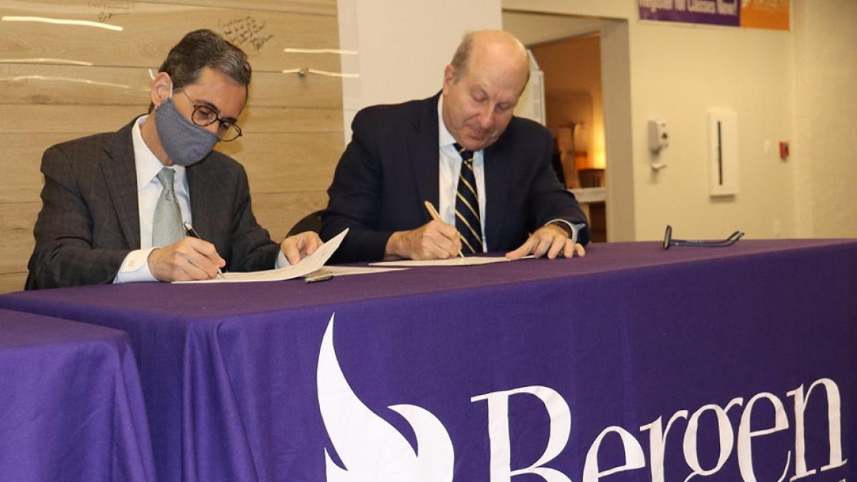 President Krislov signing papers