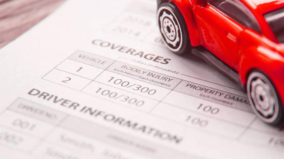 toy car on insurance paperwork representing the concept of automobile insurance