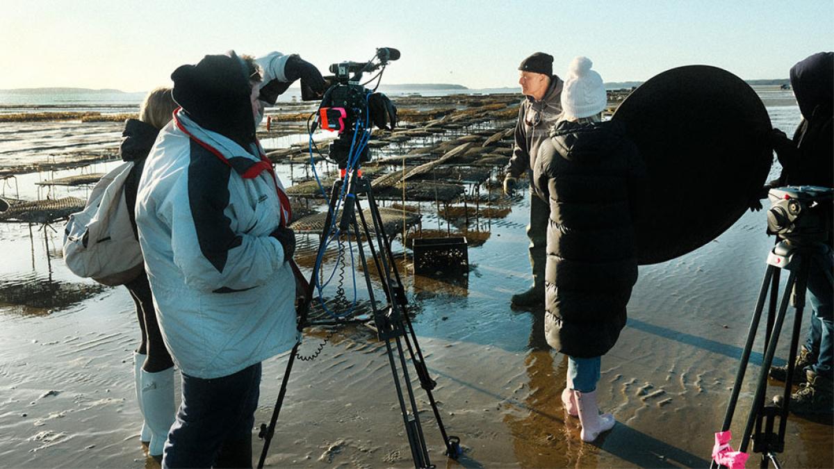 film crew at an oyster farm