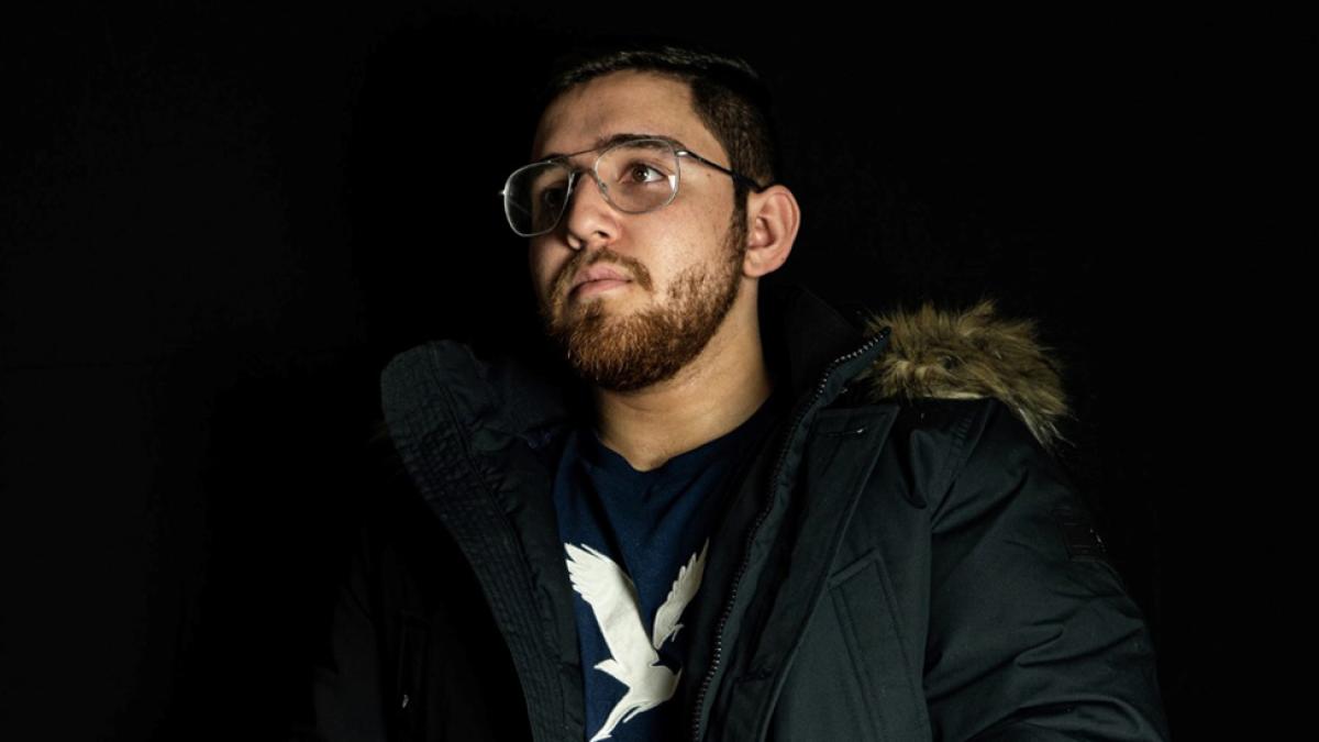 Headshot of Nicholas Lotto wearing a coat and glasses 