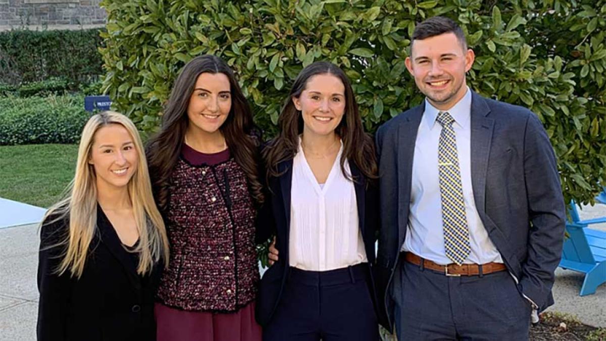 Four law students in front of Haub Law Campus