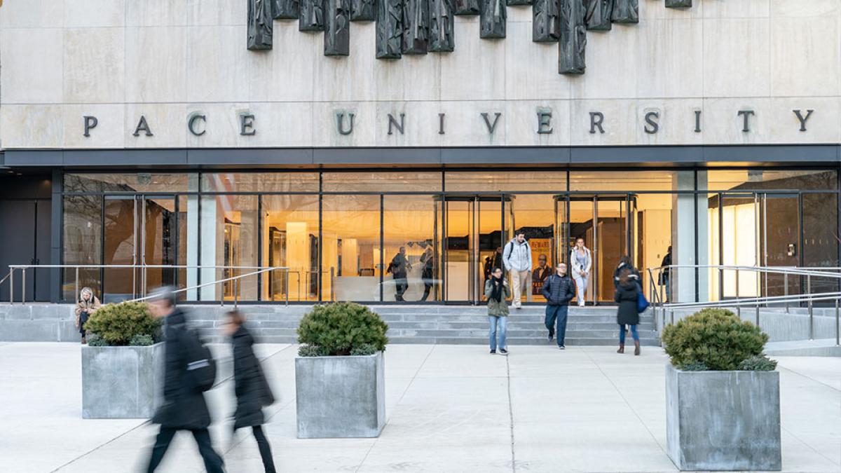 people walking in front of one pace plaza