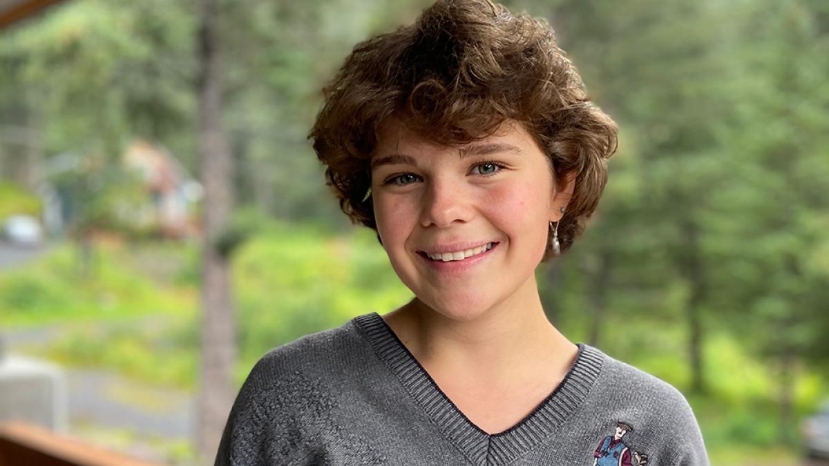 Camden Robertson, wearing a grey shirt, smiles at the camera