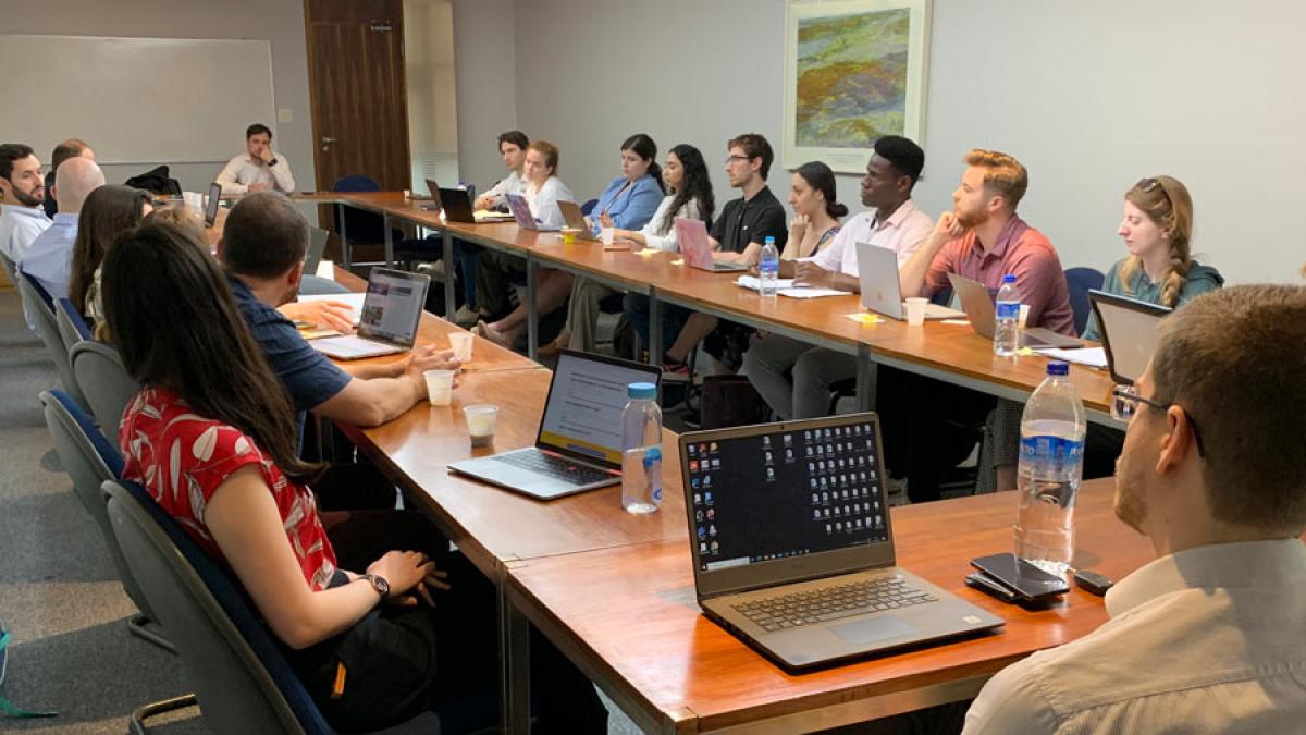 Elisabeth Haub School of Law professor speaking with students at a long table.