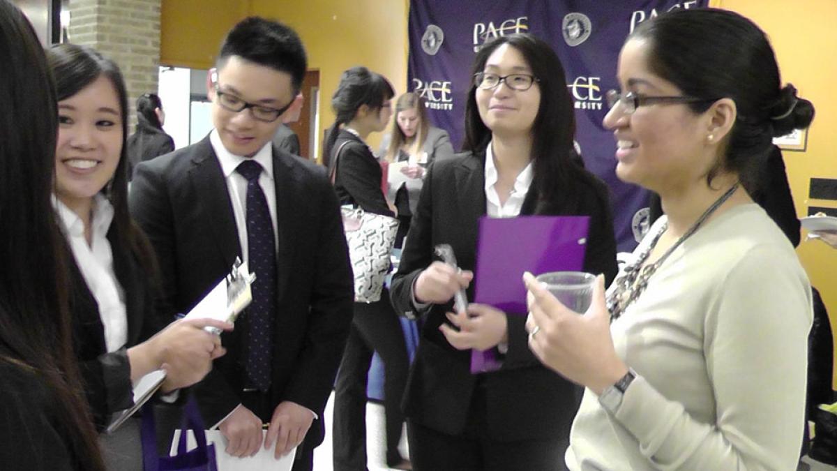 Group of Pace University Lubin students mingling at a networking event