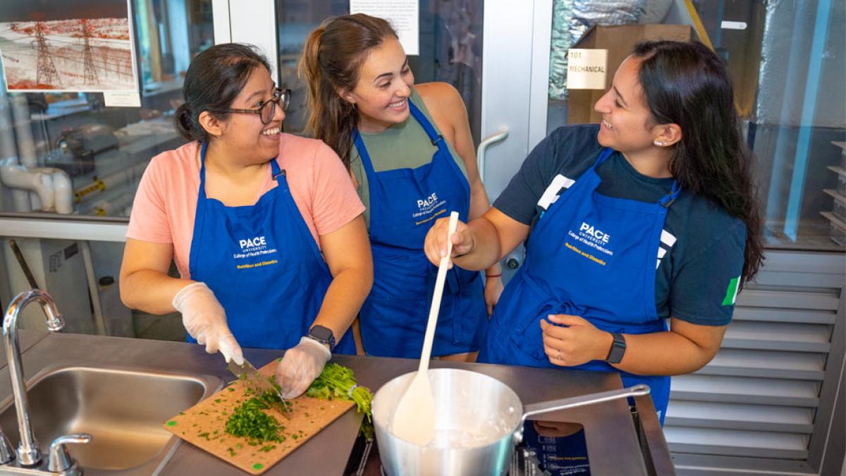 Pace nutrition and dietetics students working together in the teaching kitchen. 