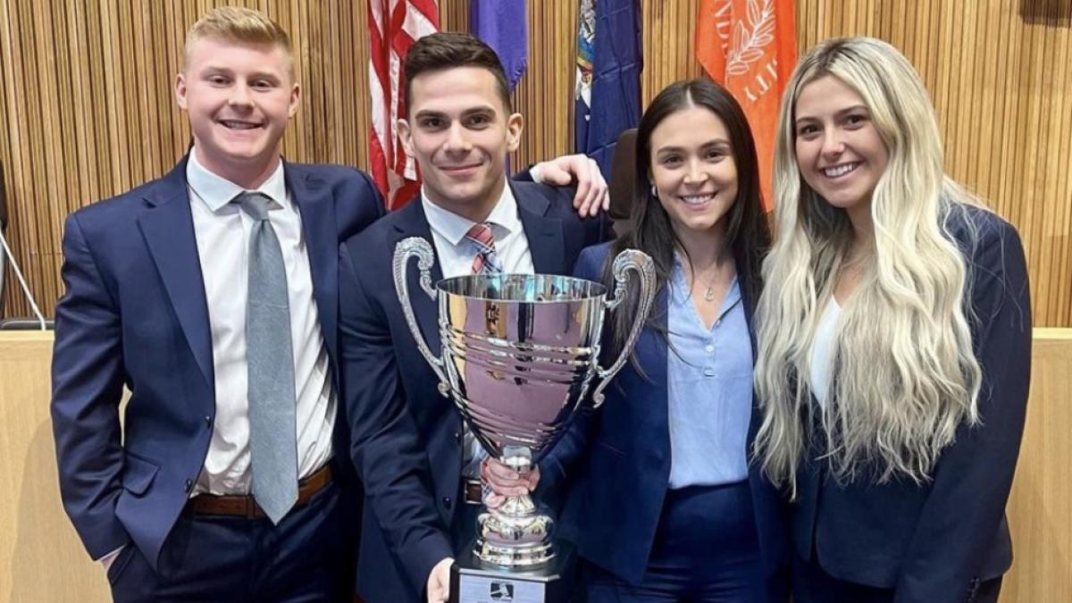 Elisabeth Haub School of Law at Pace University trial advocacy students holding trophy