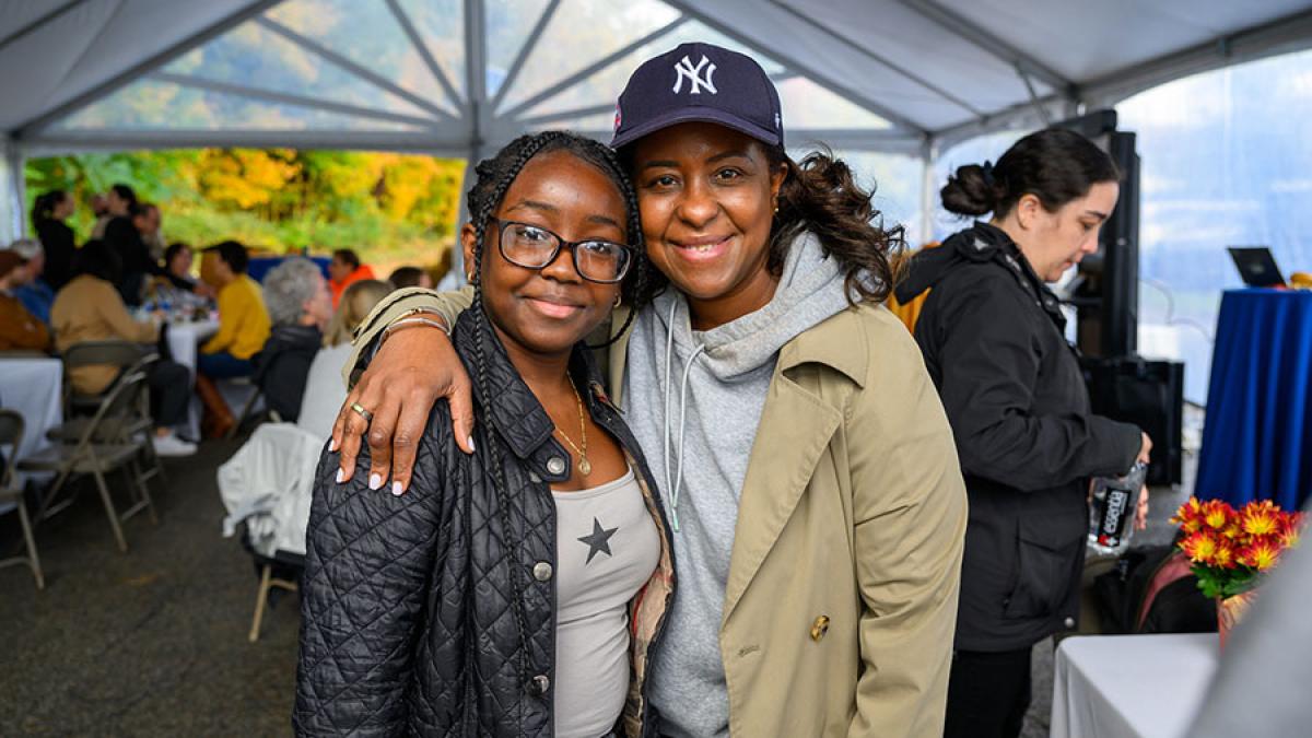 Pace University student smiling at the camera at Homecoming.