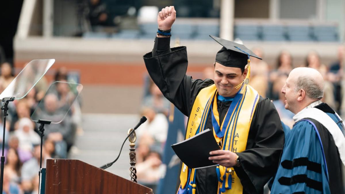 Paul Cimicata and President Krislov on stage at Commencement 2024. 