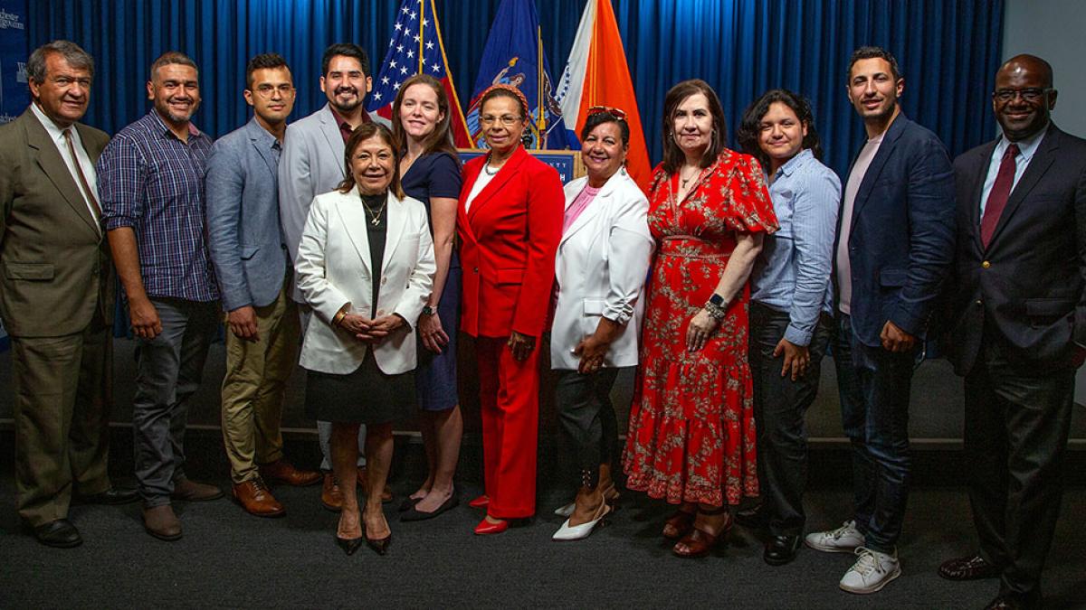 Pace University Public Administration professor Rebecca Tekula, PhD, standing with the Westchester County Hispanic Advisory Board