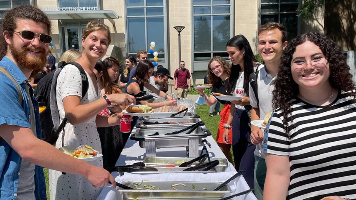Students in food line at Dean's Welcome Back BBQ.