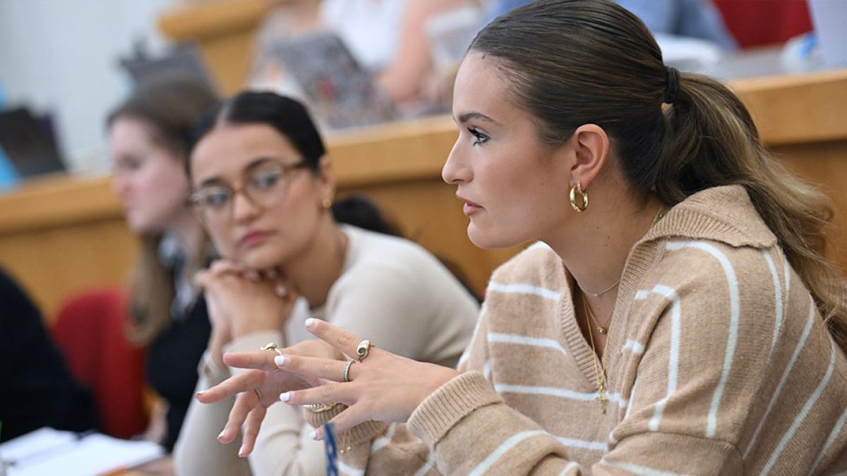 Two Elisabeth Haub School of Law students listening to a lecture.