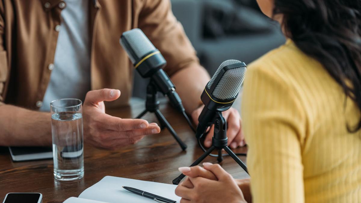 Man and woman podcasting