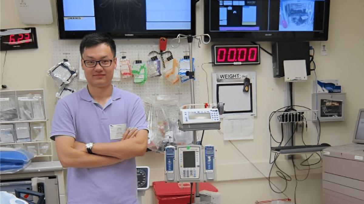 Seidenberg professor Dr. Zhan Zhang posing for a photo in front of medical equipment.